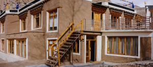 a building with a staircase on the side of it at Shan at Uley in Leh