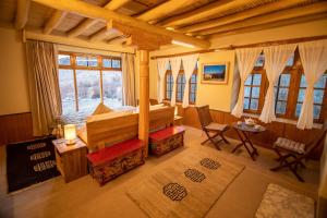 a bedroom with a bed in a room with windows at Shan at Uley in Leh