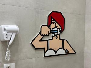 a sticker of a man brushing his teeth in a bathroom at Corsica Rooms in Termoli