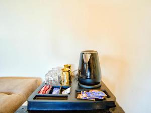 a coffee table with a vase on top of it at Casa Pajaros in Calangute