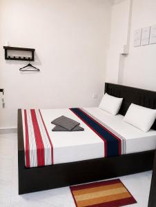 a bedroom with a bed in a room at New Happy bay in Arugam Bay +5 photos