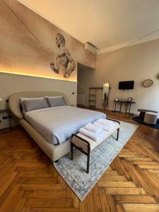 a bedroom with a bed with a statue on the wall at The Orso Suite -Brera in Milan