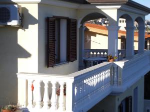 a balcony of a house with a blue railing at B&B La Collina in Posada