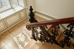 a staircase with a wooden rail and a window at Henriks Hotel in Copenhagen