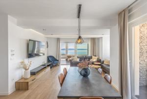 a living room with a table and a couch at Villa Collis in Makarska