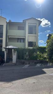 a white house with a car parked in front of it at Como Gate - 10 minuti dal centro in Lucino