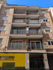 an apartment building with balconies and a sign in front of it at SUNSHINE GROUP in Málaga