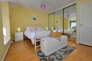 a bedroom with a bed with pink pillows at Finest Retreats - Delfryn in Talysarn