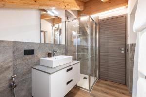 a bathroom with a sink and a shower at ChaletMafi in Valdidentro +66 photos