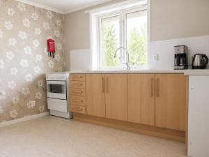 a kitchen with a sink and a window at Solbacka apartments Norr - Panorama view in Södra Ås