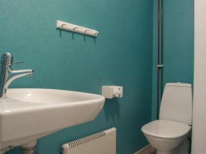 a bathroom with a white sink and a toilet at Solbacka apartments Norr - Panorama view in Södra Ås