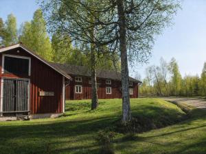 a red barn in a field with trees at Solbacka apartments Norr - Panorama view in Södra Ås