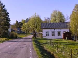 a white building on the side of a road at Solbacka apartments Norr - Panorama view in Södra Ås +4 photos