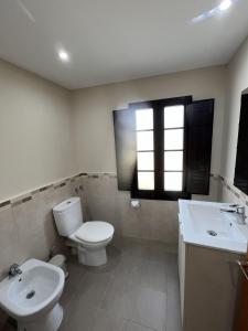 a bathroom with a toilet and a sink at El Encanto de Sixto in Santa Marta de Ortigueira +25 photos