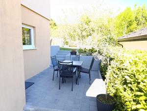 a patio with a table and chairs on it at Apartman Andrea in Posušje