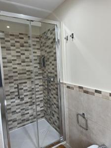 a shower with a glass door in a bathroom at El Encanto de Sixto in Santa Marta de Ortigueira