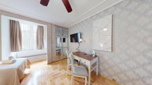 a bedroom with a desk and a bed and a television at Śnieżka in Krosno
