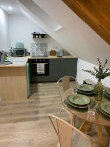 a kitchen and dining room with a table and chairs at Amelia in Saint-Aignan +4 photos