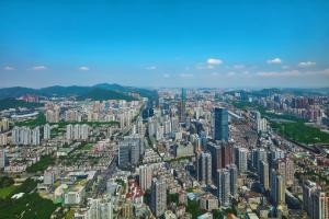 an aerial view of a city with tall buildings at The St. Regis Shenzhen in Shenzhen