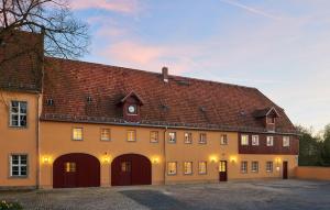 a large building with a large brown roof at Rittergut Hirschbach in Glashütte