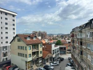 a city with cars parked in a parking lot at Central apartment 4 in Gnjilane