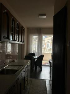 a kitchen with a table and chairs in a room at Central apartment 4 in Gnjilane +11 photos