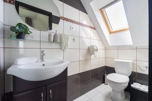 a bathroom with a sink and a toilet at KisEtyek Vendégház in Etyek