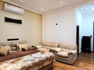 a living room with a couch and two couches at Isle Weligama in Weligama