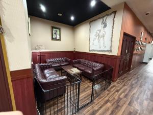 a waiting room with leather couches and a horse on the wall at HOTEL Dane&Kerry DogResort in Ishioka