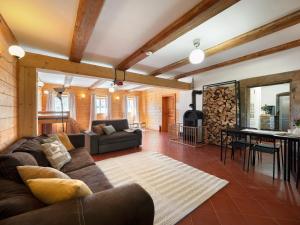 a living room with a couch and a table at Chalupa Domovina in Jiřetín pod Jedlovou