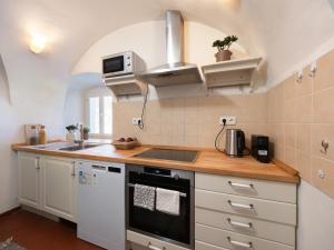 a kitchen with a sink and a stove top oven at Chalupa Domovina in Jiřetín pod Jedlovou