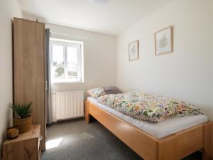 a bedroom with a bed and a window at Chalupa Domovina in Jiřetín pod Jedlovou
