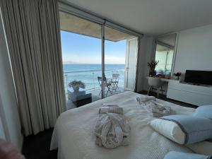 a bedroom with a bed with a view of the ocean at C'est la vie! in L'Escala