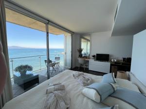 a bedroom with a large bed with a view of the ocean at C'est la vie! in L'Escala