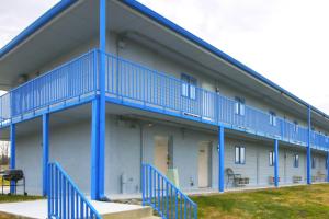 a building with blue balconies on the side of it at Marshall Lodge By OYO Hwy 65 in Marshall