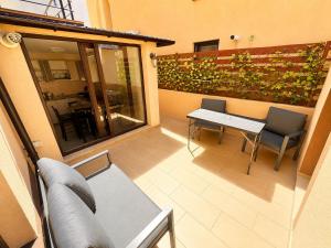 a small balcony with a table and chairs in a building at Holidays Summer Vibes Apart Mamaia Nord in Năvodari