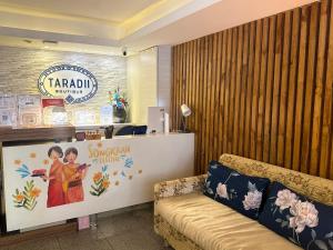 a waiting room with a couch and a sign at Taradii Boutique in Bangkok