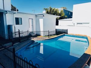 a swimming pool in front of a house at Resort-style living -pool in Bass Hill