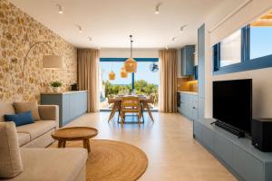 a living room with a kitchen and a dining room at Villa Pollux in Gennadi