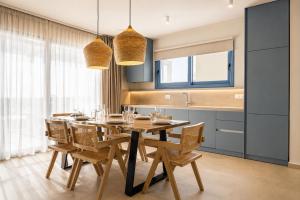 a dining room with a wooden table and chairs at Villa Pollux in Gennadi