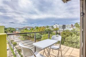 a balcony with a table and chairs and a view at The Link Sandton Apartment in Johannesburg