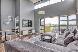 a living room with a couch and a table at The Link Sandton Apartment in Johannesburg