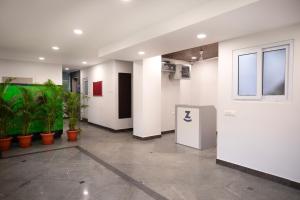 an empty room with plants in a building at Z Express Anoop in Bangalore