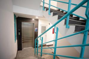 a staircase in a building with blue railings at Z Express Anoop in Bangalore