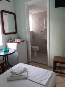 a bathroom with a toilet and a sink and a mirror at Anastasia Studios in Tinos