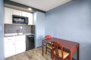 a small kitchen with a table and chairs and a microwave at Marshall Lodge By OYO Hwy 65 in Marshall