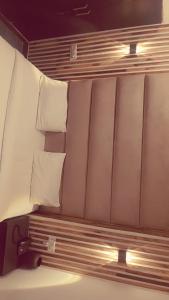a bed with white pillows in a small room at VT residency in Tājganj