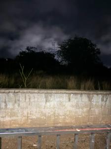 a bench in front of a wall with a dark sky at Vellora Haus in Burgersfort