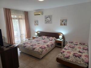 a bedroom with two beds and two lamps on tables at Морски Фар in Sveti Vlas +15 photos