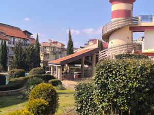 a building with a red and white tower on top of it at Морски Фар in Sveti Vlas